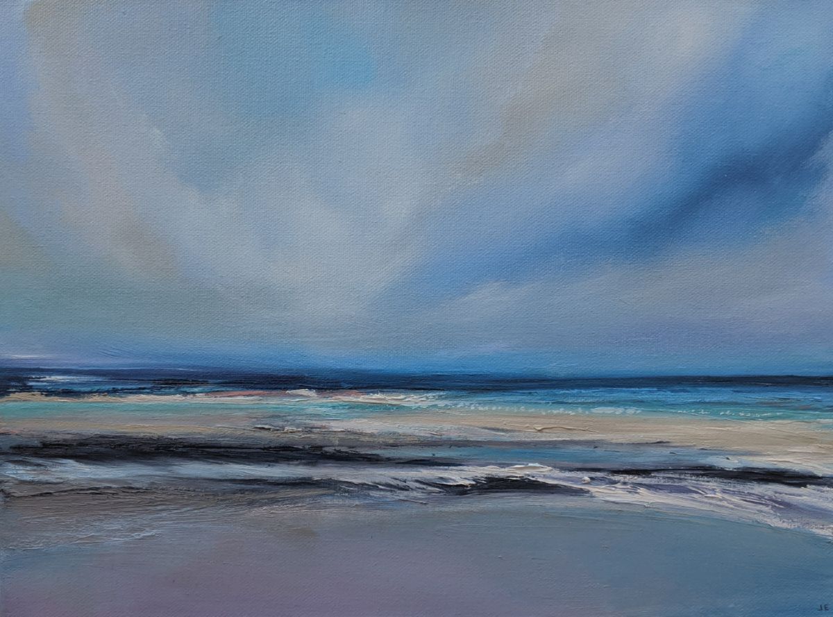 Purple Shore oil painting by Jo Earl | Blue-skied seascape with the sea in the horizon and a purple tinted beach in the foreground with ebbing waves.